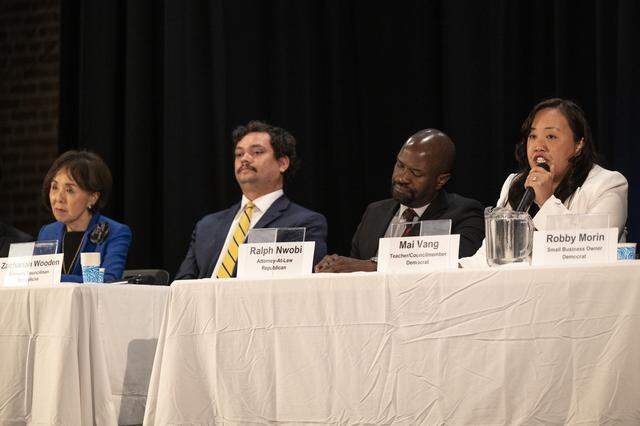 Mai Vang, right, speaks during a congressional candidate forum for CA District 7 at Coloma Center in Sacramento on Thursday, April 2, 2026, as candidates, from left, Doris Matsui, Zachariah Wooden and Ralph Nwobi listen.