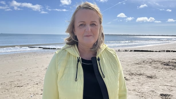 Councilor Lisa McDonald stands on Rosslare Strand.