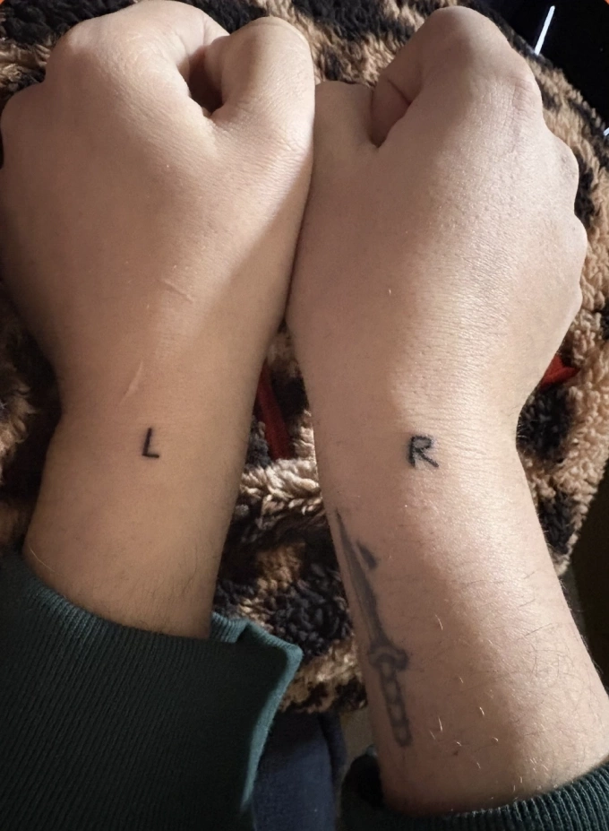 At the end of February 2026, an AX user shows tattoos on his left and right wrists to distinguish orientation. Photo credit: X/bearbubb