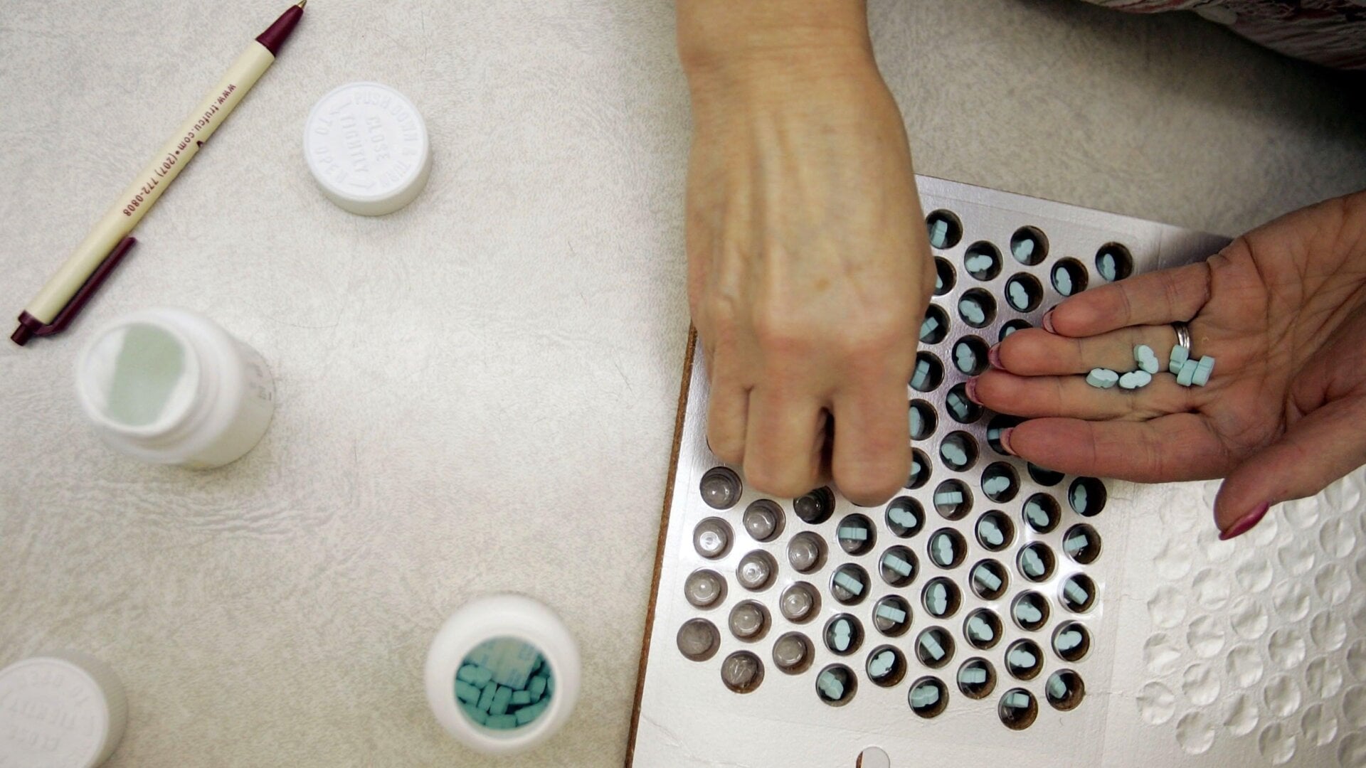 A pharmacy technician filling out a prescription